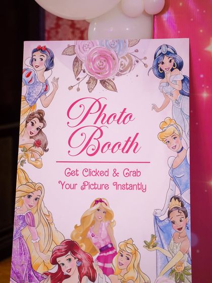 A sign for the princess photo booth, inviting guests to get their picture taken instantly.