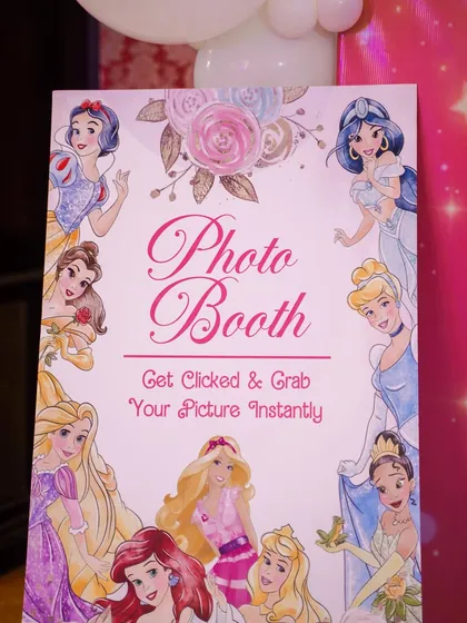 A sign for the princess photo booth, inviting guests to get their picture taken instantly.
