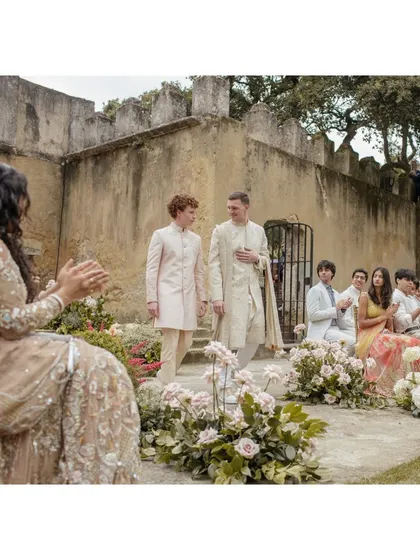 Kingsley walks down the aisle with his younger brother. This moment captures the bond between siblings and the support they offer each other on the most important days.