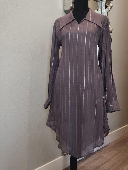 A chic and simple high-low tunic in a muted purple with subtle silver stripes. This is a versatile piece that can be dressed up or down.