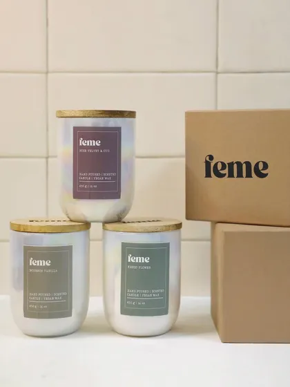 Our signature Holographic Jar candles, shown here with their gift-ready packaging. Each one is hand-poured with non-toxic soy wax, features a long-lasting 50-hour burn time, and comes with an engraved wooden lid.
