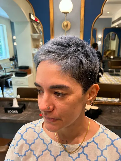 A closer look at the texture and cool ash tone of a very short crop cut. This style is all about precision and creating a shape that is both strong and feminine.