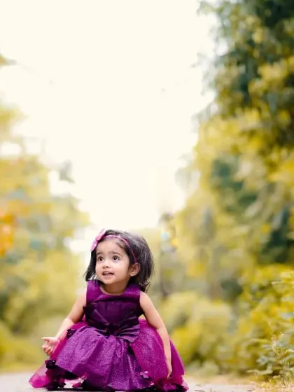 A princess in the woods. This little girl looks so lovely in her purple gown, set against the beautiful backdrop of the trees and golden sunlight.