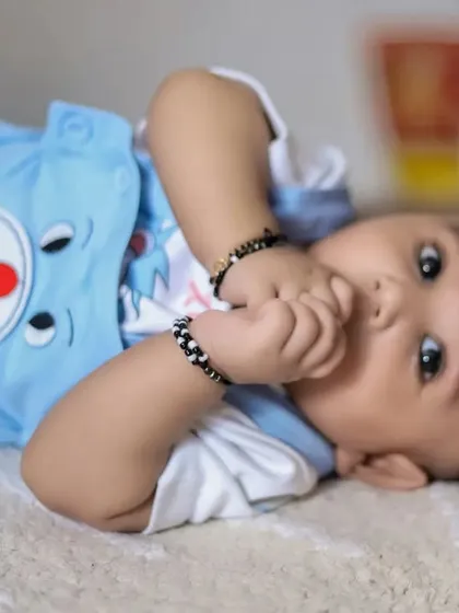 A curious baby looking right at the camera during an at-home photoshoot. We let babies be themselves to capture their emerging personalities.