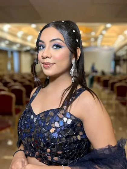 Beauty in blue. This party look features a stunning blue smokey eye that complements the mirrored lehenga, creating a modern and edgy style.