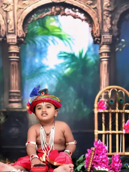 This little Krishna sits playfully among flowers and peacock decor, creating a vibrant and lively portrait.