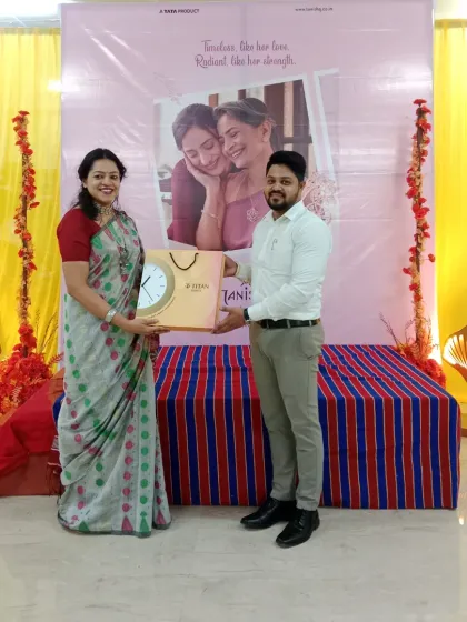 Presenting a gift to a guest during the Mother's Day celebration I hosted at Tanishq. Recognizing and rewarding customers is a great way to build a strong community around a brand during in-store activations.