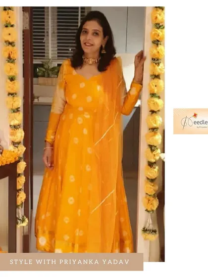 We turned a client's old saree into this bright yellow Anarkali. To complete the look, we added a new dupatta with handmade Gota work for a fresh, festive feel.