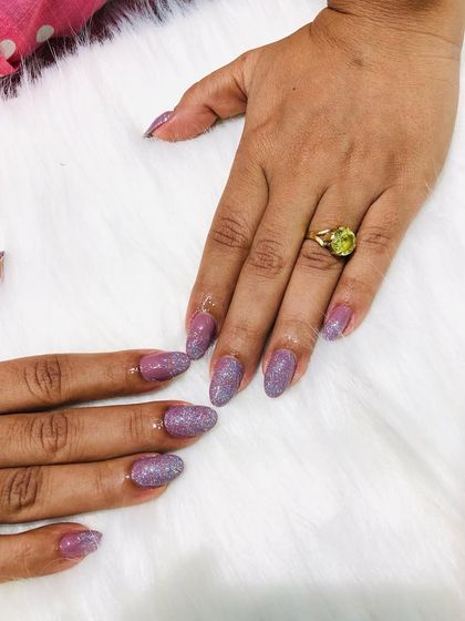 These unicorn nails feature a beautiful iridescent glitter that shifts colors in the light.