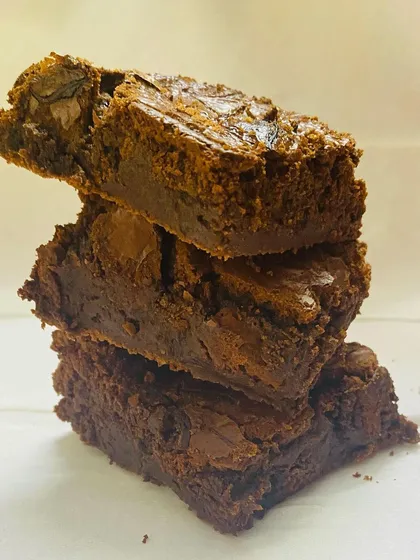 A tempting stack of my ultra-fudgy chocolate brownies. You can see the perfect crackly top and the dense, moist center that makes them a must-try for any chocolate lover.