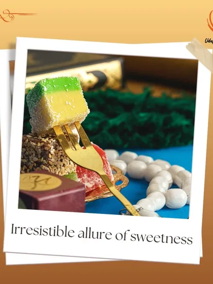 This image captures the irresistible allure of our Indian sweets. A colorful layered barfi is presented on a fork, showcasing the fine texture and artistry of our traditional dessert offerings.