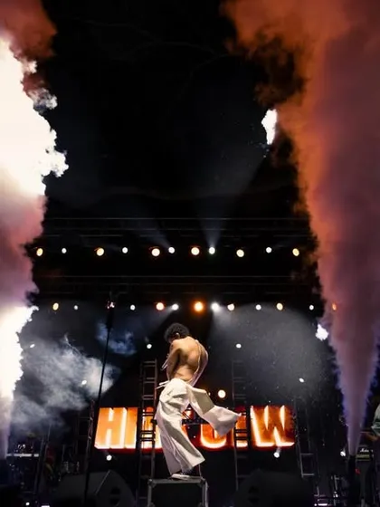 Smoke cannons erupt as Hanumankind performs, adding to the dramatic and high-energy stage production.