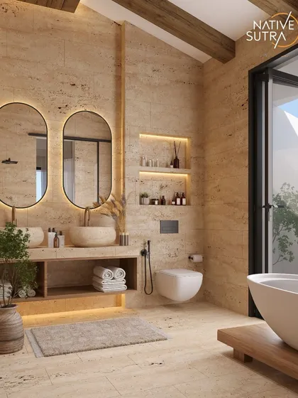 We create bathrooms that feel like private spas. This space uses earthy travertine tiles, floating vanities with stone basins, and softly lit niches to create a sense of calm craftsmanship. It’s a testament to our belief that even the most functional rooms should be designed to heal and soothe.