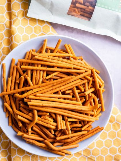Crispy, crunchy, and full of flavor, my Tikha Gathiya is the perfect companion for chai. This image shows a bowl of gathiya sticks ready for a tea break.