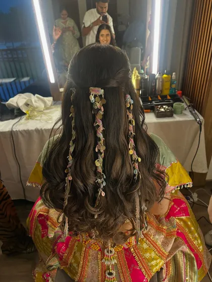 Bridal hair is an art form. This unique hairstyle, featuring soft waves and delicate, cascading accessories, is an example of the creative and beautiful hair inspirations we offer our brides.