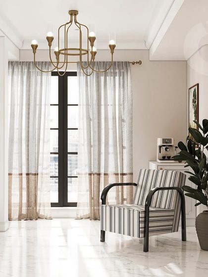 A quiet reading corner in the master bedroom. The striped armchair, classic chandelier, and full-length mirror are carefully chosen to create a sophisticated nook that feels both timeless and comfortable, enhanced by natural light from the large window.