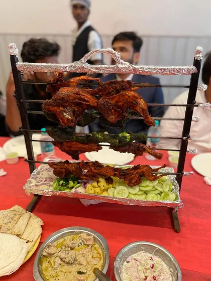 A "Groom's Table" special. This tiered stand presents a variety of grilled items, including tandoori quail and different types of kebabs.
