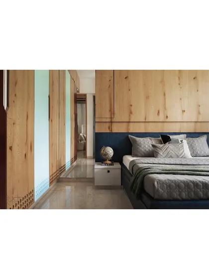 Another view of the teenager's room, showing the full expanse of the wooden wardrobe and wall panels.