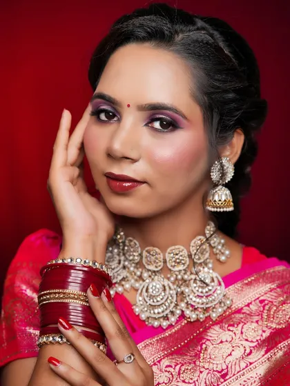 A close-up of the saree look, highlighting the beautiful contrast between the pink saree and the purple-toned eyeshadow.