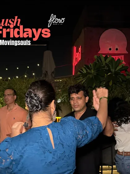 A lively salsa turn on the crowded dance floor. This captures the dynamic and social nature of the dance, with other dancers enjoying the night in the background.