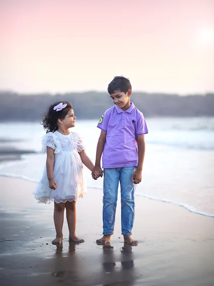 The simple, pure bond between siblings, captured against the backdrop of a soft Mumbai sunset. We love taking sessions outdoors to let kids be kids, resulting in natural, candid moments like this one that you'll cherish forever.