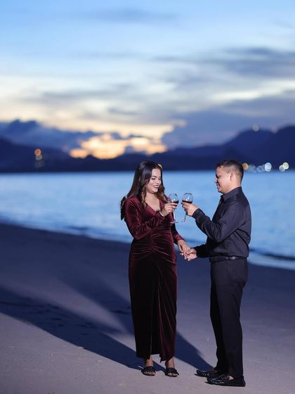 A toast to their future. The makeup is elegant and sophisticated, perfect for this celebratory moment during their destination shoot.
