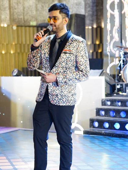 Mic in hand, ready to get the party started at a wedding reception. I move around the stage to engage with guests from all corners, making everyone feel included.