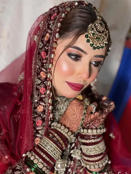 A close-up of this beautiful bride, showing the detailed eye makeup with a hint of glitter and a perfectly blended base. The maroon and green combination is a personal favorite.