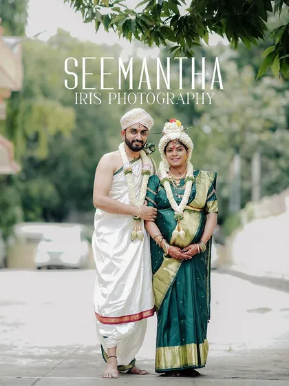 A formal portrait of a couple dressed in traditional attire for their Seemantha ceremony. This photo showcases the cultural richness and serene beauty of the event, taken outdoors in Bangalore.