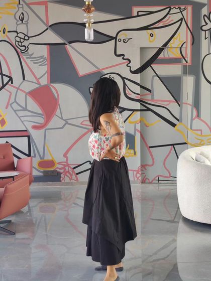 The artist standing before the reimagined 'Guernica' mural, providing a sense of scale and the personal connection we forge with each project.