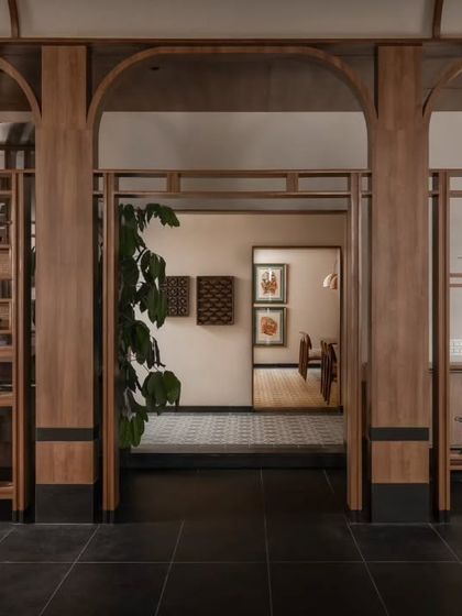 Wooden archways and open shelving act as subtle space dividers, creating a sense of discovery as you move through the restaurant. This architectural detail helps define different areas without closing them off, maintaining an open and airy feel.