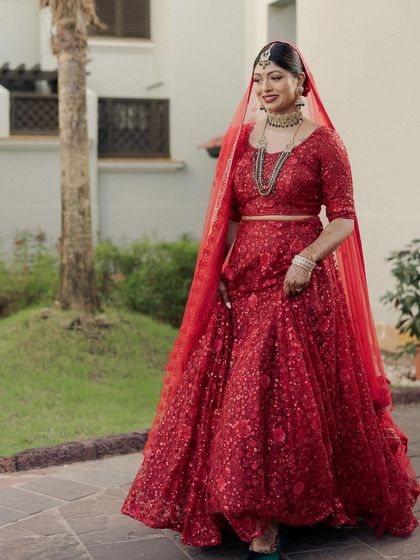 My bride Kavi, ready for her reception in a dazzling all-red sequin lehenga. We paired it with a classic bold red lip and a sharp winged liner for a truly show-stopping look.