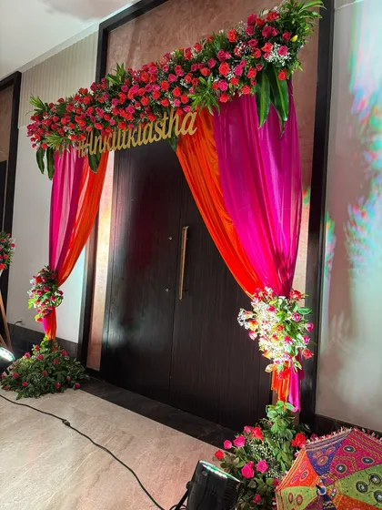 The entrance to your event should make a statement. For this Mehendi, I created a stunning floral archway with bright pink and orange drapes, setting a vibrant and welcoming tone from the moment guests arrived.