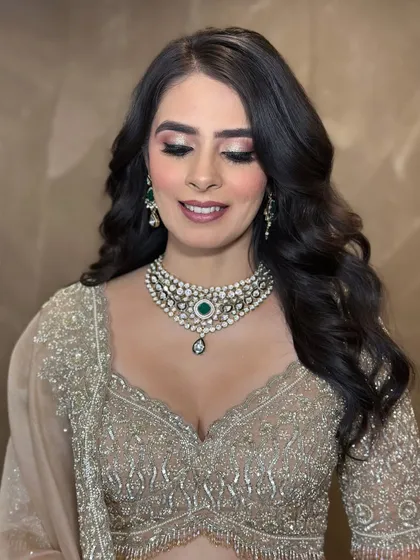 A stunning engagement look. The makeup features a soft, shimmery cut-crease on the eyes, paired with a nude lip and beautiful, voluminous waves for a glamorous yet elegant style.