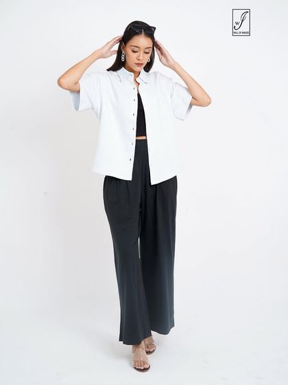 A full-length pose that shows the complete, casual-chic outfit.