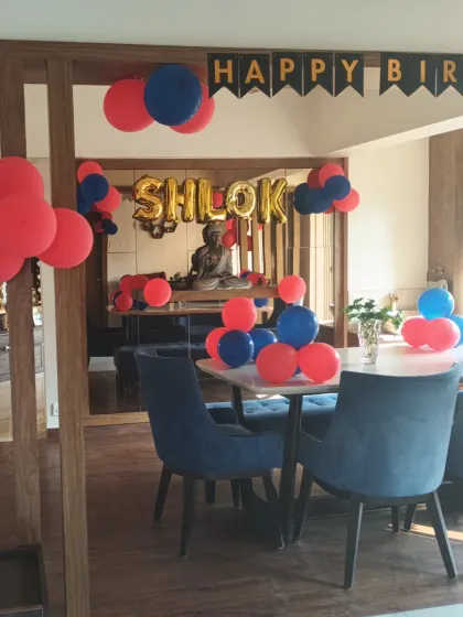The full view of the living and dining area decorated for a birthday.