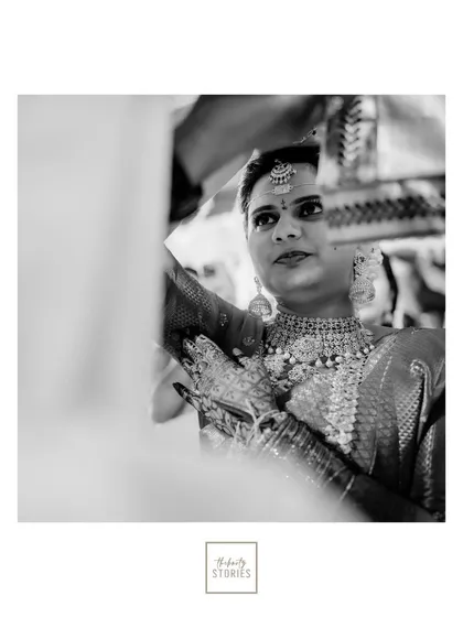 A classic black and white portrait of the bride during her ceremony, capturing her focused and serene expression from an intimate perspective.