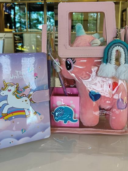 Another unicorn-themed gift set for kids, featuring a plush toy, a diary, and a macrame rainbow keychain.