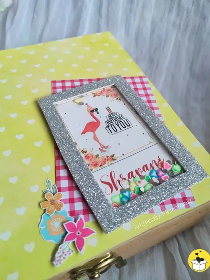 The top of a custom birthday hamper box, decorated with a personalized shaker frame for the birthday girl.