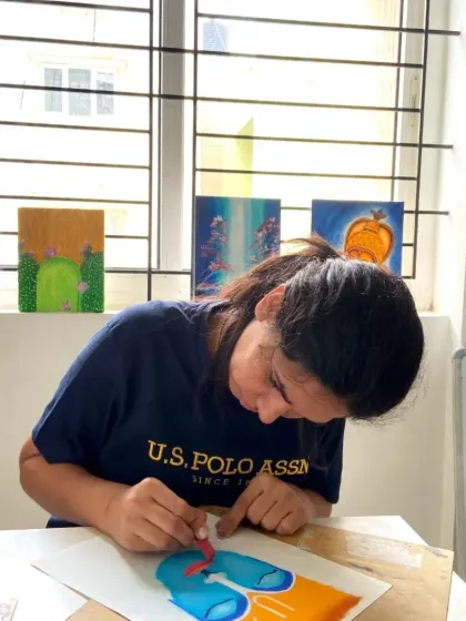 This student is exploring oil pastels, learning how to layer colors to create vibrant and expressive artwork in our CFA program.