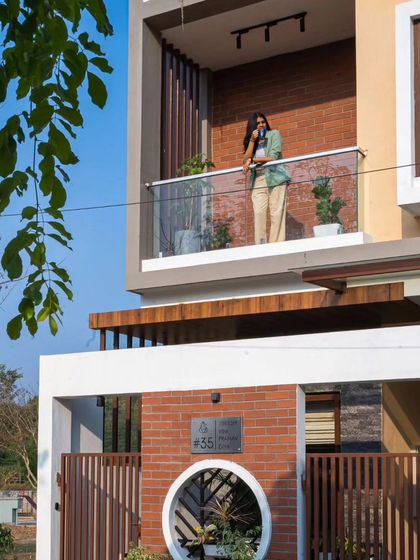 Another detail of the Sarjapur facade, capturing the modern aesthetic and the integration of small green elements.