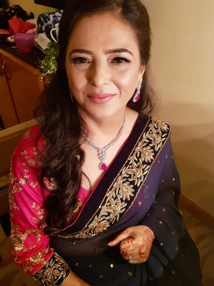Grace and elegance for the mother of the bride. This look is about enhancing her natural beauty with a soft, glowy finish, defined eyes, and a lovely lip color that complements her beautiful saree.