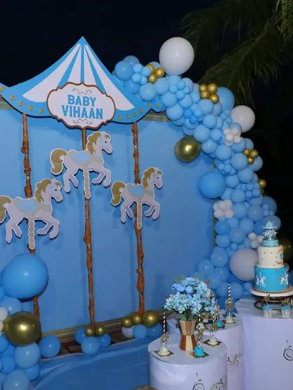 A close-up of the lit-up carousel stage at night, with the birthday cake on display.