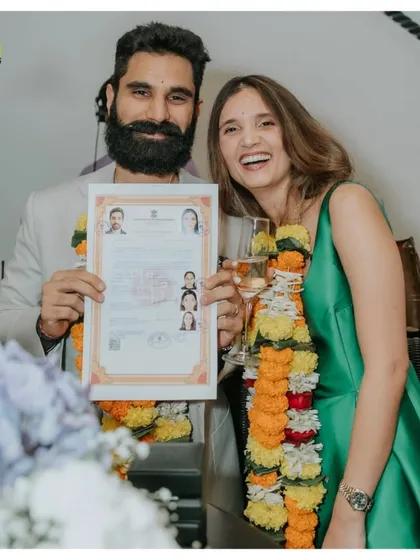 The newly married couple proudly displays their marriage certificate, a simple yet profound moment of legal union.