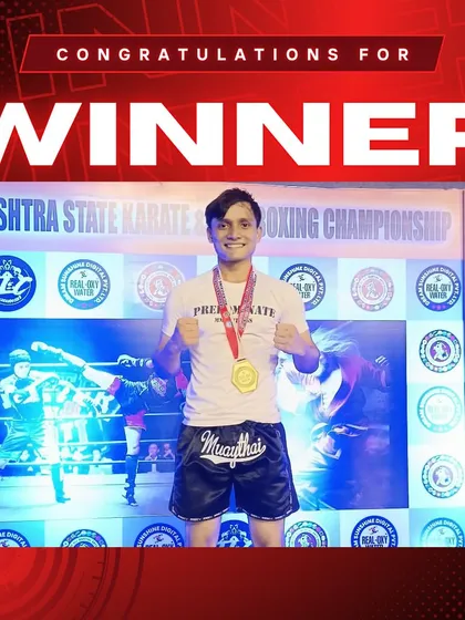 Another champion from our team, proudly displaying his gold medal after a victorious kickboxing tournament.