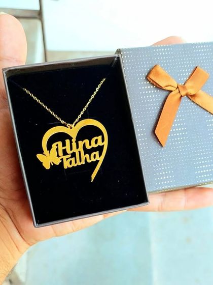 Here is another view of the heart-shaped couple's name pendant, shown inside its gift box. The presentation makes it a ready-to-give gift for any special occasion.