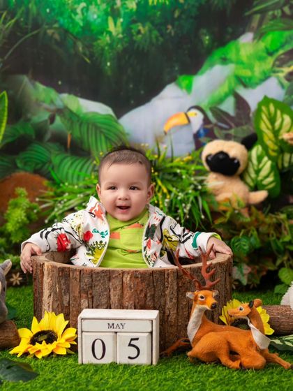 A big smile from the jungle. This happy baby is clearly enjoying his adventure in my lush and green jungle-themed setup.