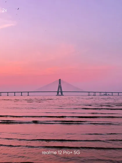 This 2x zoom shot of the Sea Link, taken on a mobile phone, provides a classic landscape view, balancing the bridge with the expansive sea and sky.