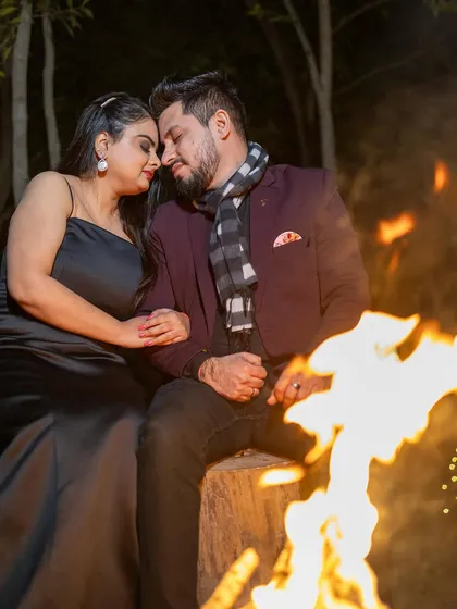 A cozy evening scene by the fire. The makeup is warm and glowing, perfect for this intimate and romantic pre-wedding moment.