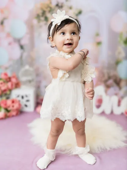 Another proud standing moment from this little girl's first birthday studio session.